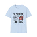 Tattoo Lover T‑Shirt — “Suspect Claims to Be Broke but Always Has Money for Tattoos”